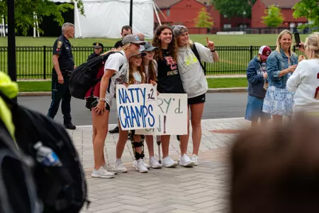 BC lacrosse players pose for a photo with fans at the National Championship celebration at Alumni Stadium.