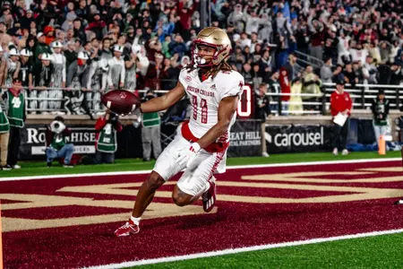 Leis bond hands the ball off after crossing the goal line for a fourth-quarter touchdown against Michigan State.
