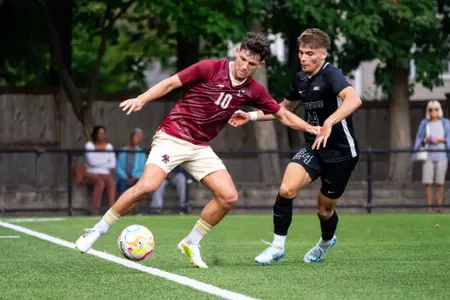 Leo Guarino holding off Providence defender