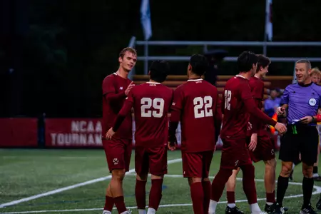 Men's Soccer celebrating goal against AIC
