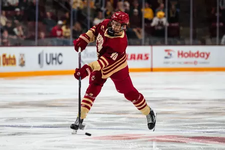 Will Moore shooting the puck against Minnesota