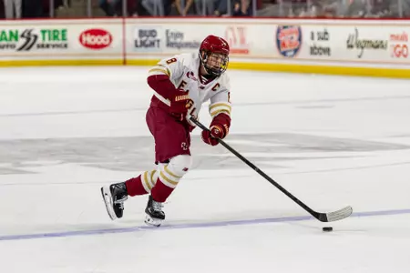 Lukas Gustafsson skating with the puck against Quinnipiac