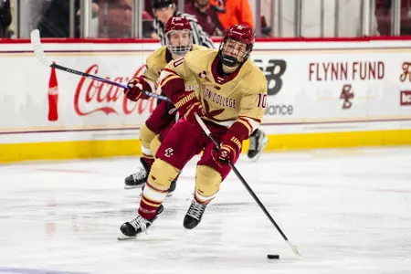 James Hagens skating with the puck against Denver
