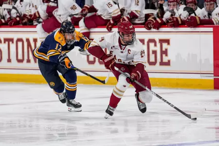 Andre Gasseau holding off Quinnipiac player