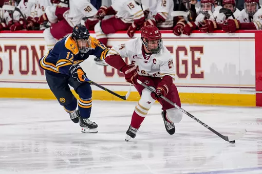 Andre Gasseau holding off Quinnipiac player