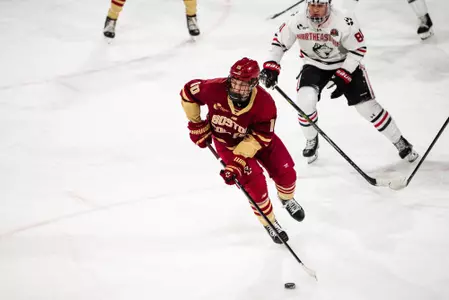 James Hagens skating with puck against Northeastern