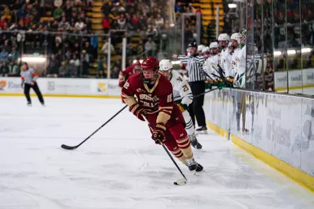 Jake Sondreal skating with the puck against Vermont