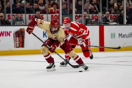 Gabe Perreault skates across the blue line vs. BU in the Beanpot Championship at TD Garden.
