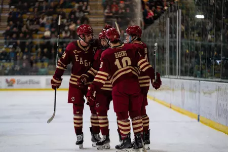Men's Hockey celebrates goal against Vermont