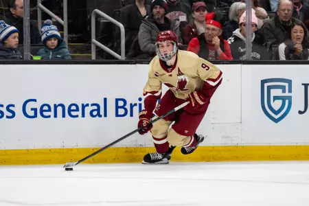 Ryan Leonard skates with the puck along the boards vs. Northeastern at TD Garden in the Beanpot Semifinals.