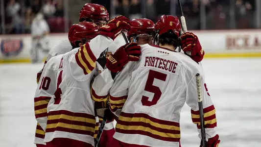 Huddle after scoring goal against UMass Lowell