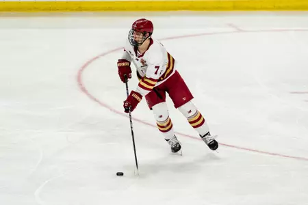 Aidan Hreschuk skating with the puck against Northeastern