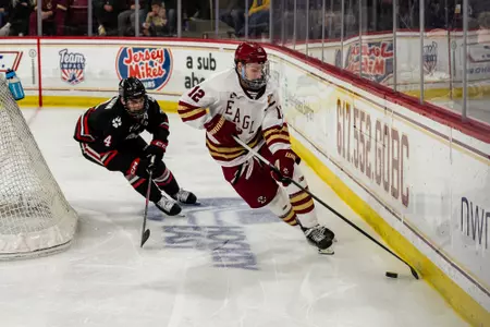 Mike Posma skating with puck against Northeastern