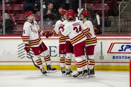 Men's Hockey celebrates goal against Merrimack