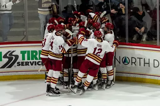 Men's Hockey celebrating after defeating UConn