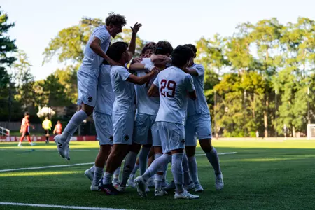 Men's Soccer celebrating goal against Northeastern