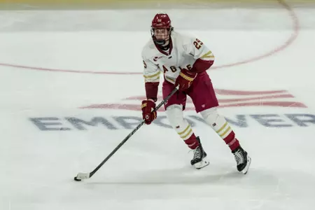 Dean skating with the puck against UMass Lowell
