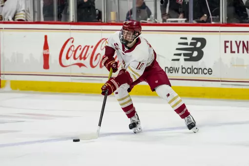James Hagens skating with puck against Merrimack