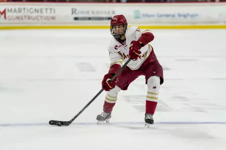 Aram Minnetian passing the puck against Merrimack
