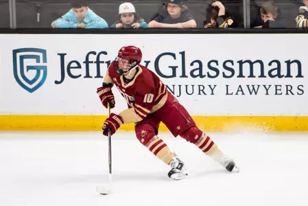 James Hagens skating with the puck.