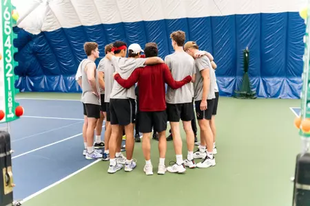 men's tennis groups huddle