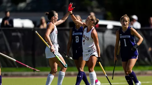 Laila Rosenquest and Alex De Cain high five against Northwestern