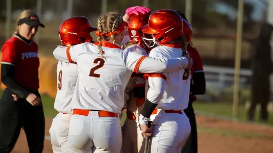 The Falcons celebrate the final run of Wednesday's DH, as Hanna Massaro (4) scored on a Katie Hutter sac fly