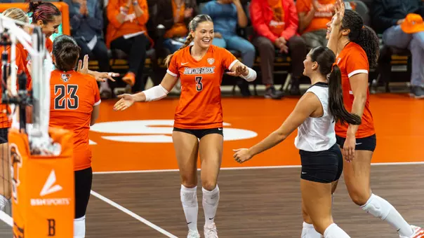 Avery Anders celebrates a point with Sydnie Herandez at the Stroh Center