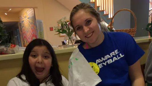 University of Delaware Volleyball Players Decorate T-Shirts With Children at Ronald McDonald House