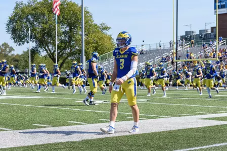 Cade Pribula walking sideline
