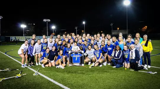Members of the women's lacrosse team pose with B+ teammate, Hayden