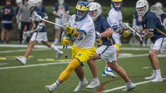 Charlie Kitchen craddles the ball with a Drexel defender draped all over him