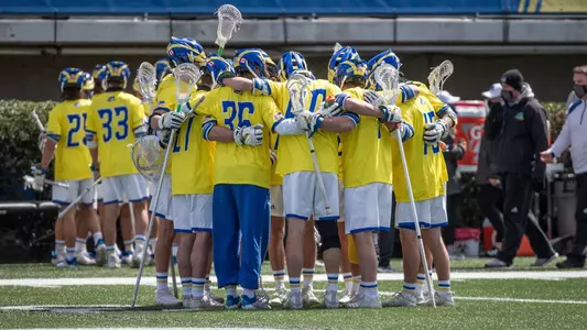 The men's lacrosse starters huddle before taking the field against Fairfield