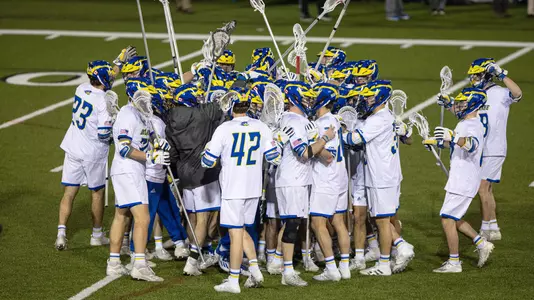 Men's lacrosse team celebrates aftering beating Saint Joseph's