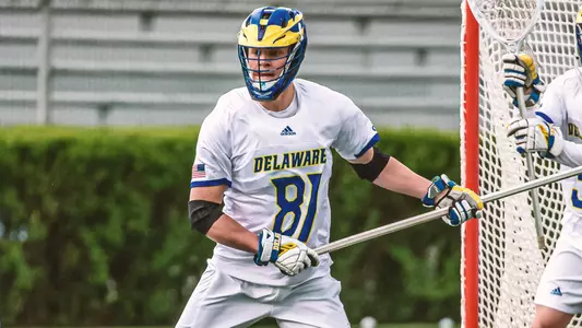 Owen Grant playing defense against UMass in the 2021 regular season finale