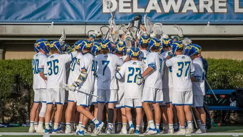 The Delaware men's lacrosse team huddles before its game against UMass.