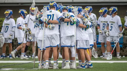 Men's lacrosse starters huddle before the regular season finale against UMass