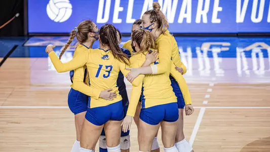 The volleyball team huddles during a match during the spring of 2021