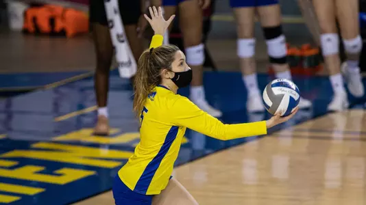 Rogers goes to serve for the Blue Hens against West Virginia