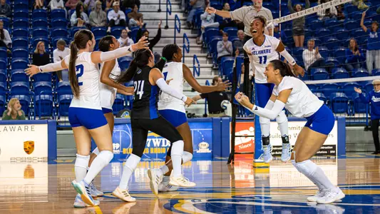 Jayda Redd and Sila Ozyurek celebrate with Aubrey Lyssy, Raina Hughes, Cadence Nguyen, and Thalia Yancey in the fourth set of Delaware Volleyball's come-from-behind victory of Middle Tennessee.