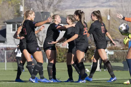 Boise State soccer players celebrate a goal.