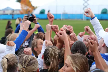 Boise State soccer players cheer in the huddle after a match.