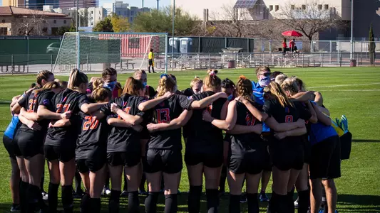 Boise State soccer players huddle at practice.