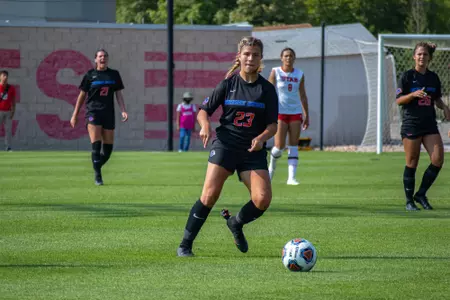 Boise State soccer player Kenzie MacMillan watches the ball after making a pass.