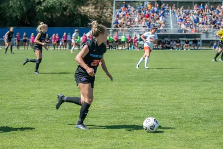 Boise State soccer player Abby Bivens dribbles the ball up the field.