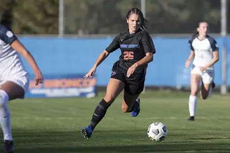 Boise State soccer player Morgan Miles dribbles the ball up the field.