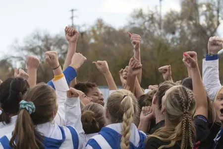 Boise State soccer players cheer in the huddle after a match.
