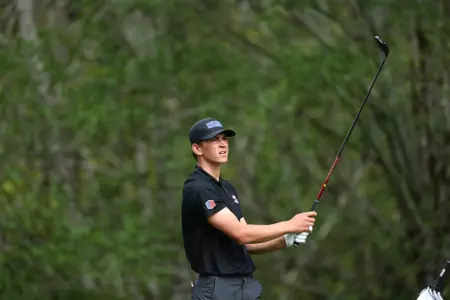 Max Charles tracks his tee shot during the Mountain West Championships.