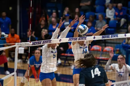 Noelani Helm and Annie Kaminski block a shot during the Utah State match, October 10, 2023.
