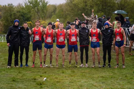 The men's cross country team posed together.